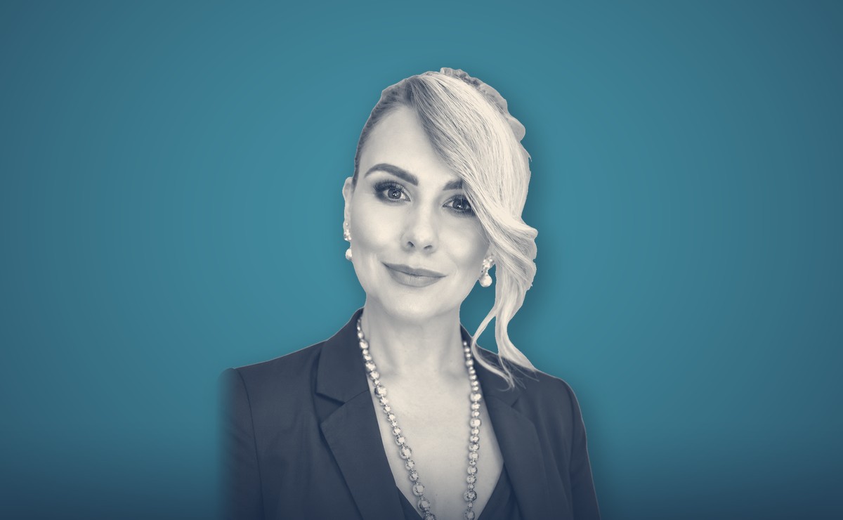 Clare Rushby, portrait on a teal background