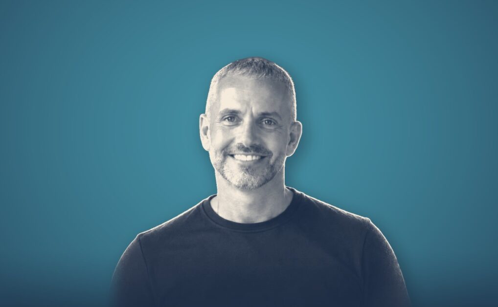 Darren Hulme, portrait on a teal background