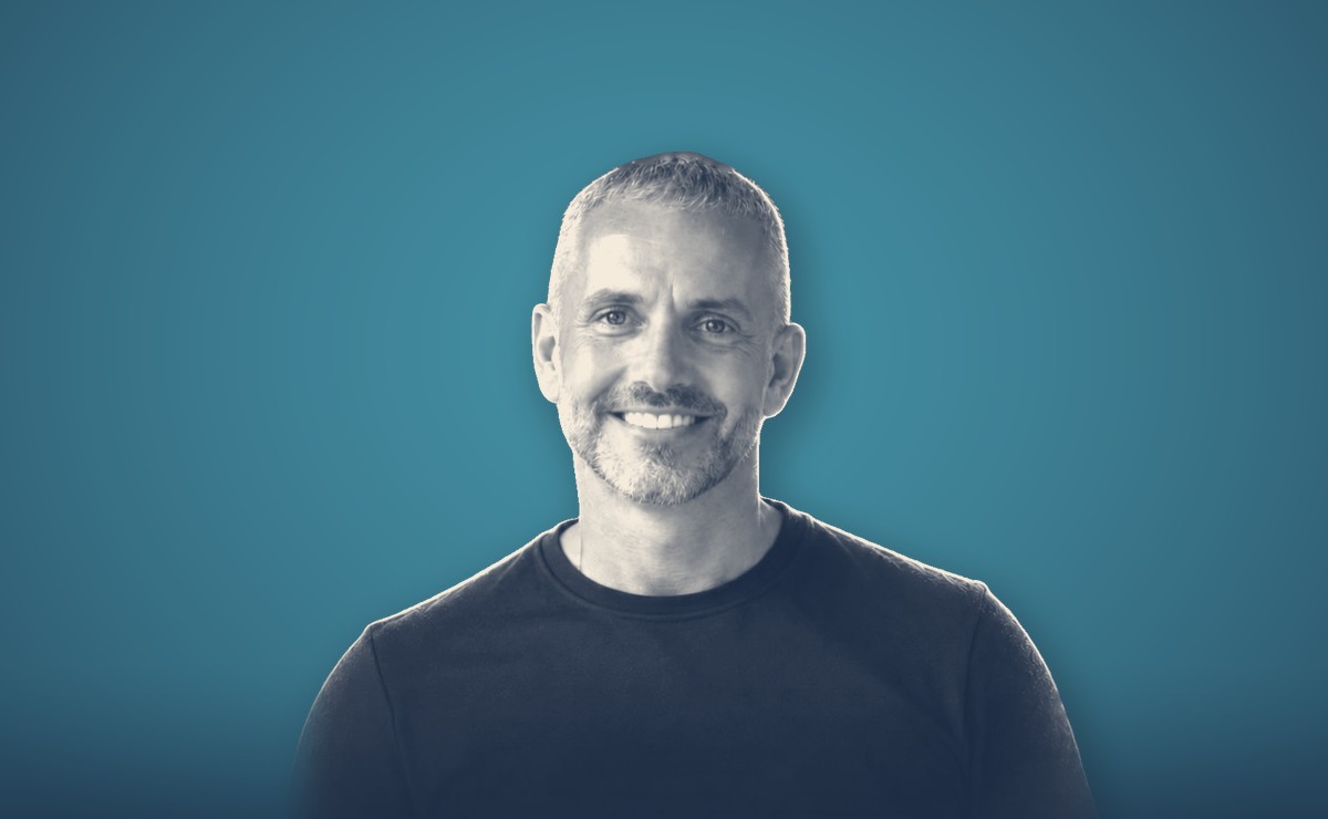 Darren Hulme, portrait on a teal background